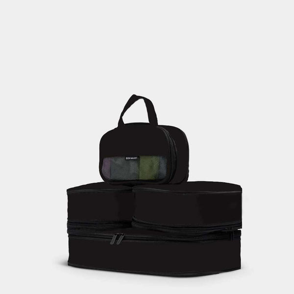 Set of black packing cubes on a light gray background