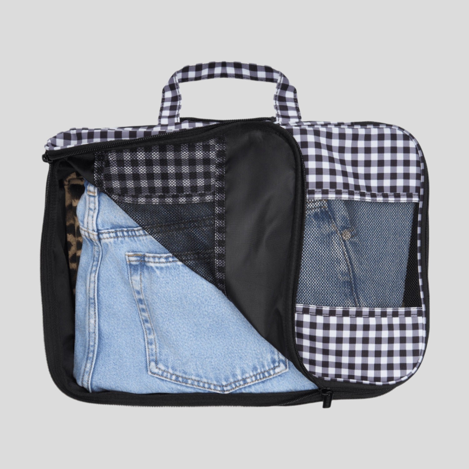 Black and white checkered bag with denim fabric inside on a white background