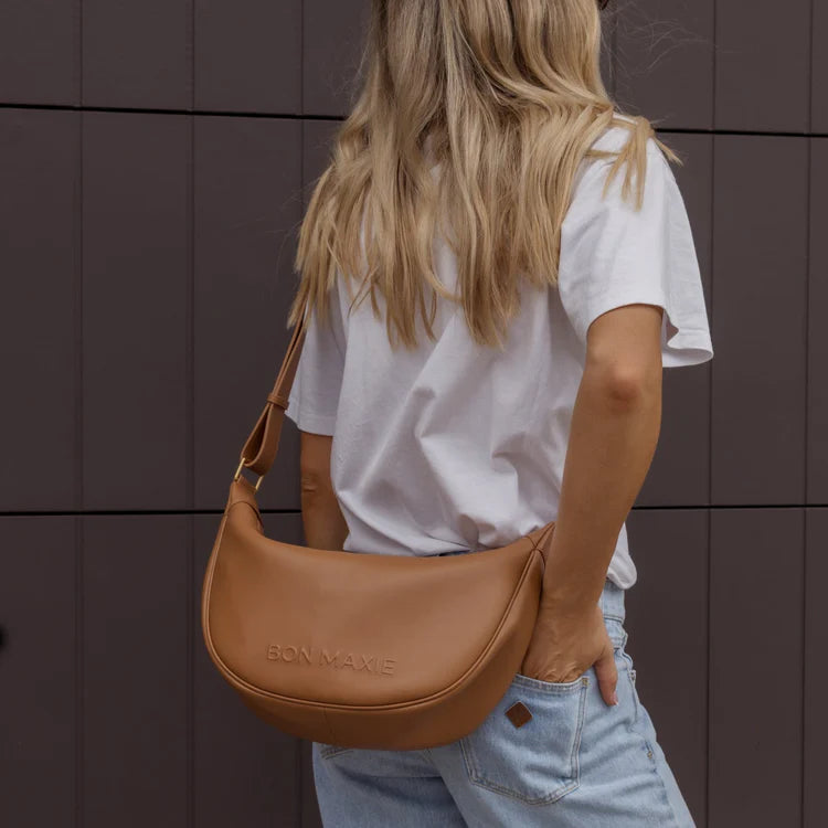Bon Maxie Slouchy Crescent Bag in tan, worn crossbody