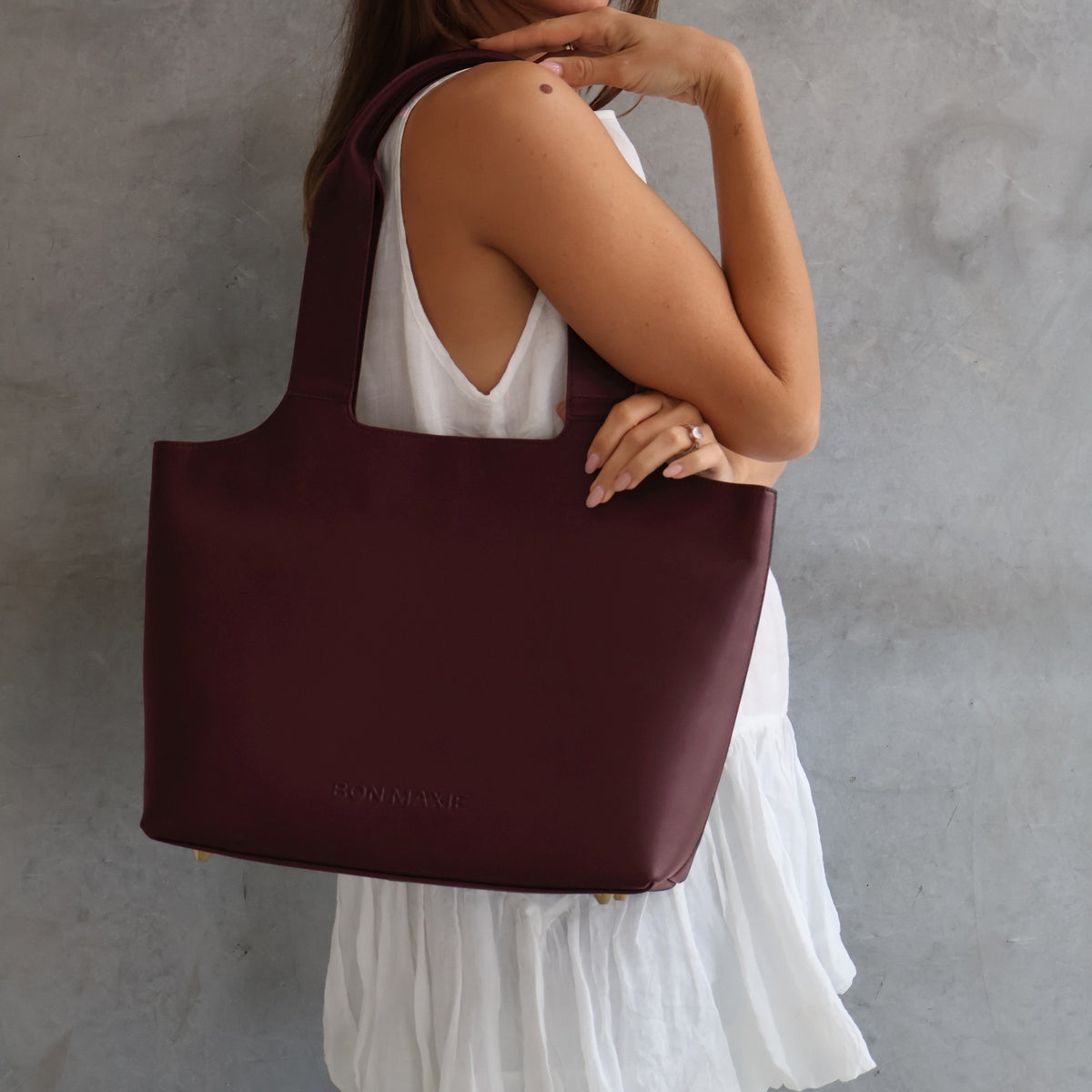 Maven Tote in Burgundy Nappa Leather, worn on the shoulder