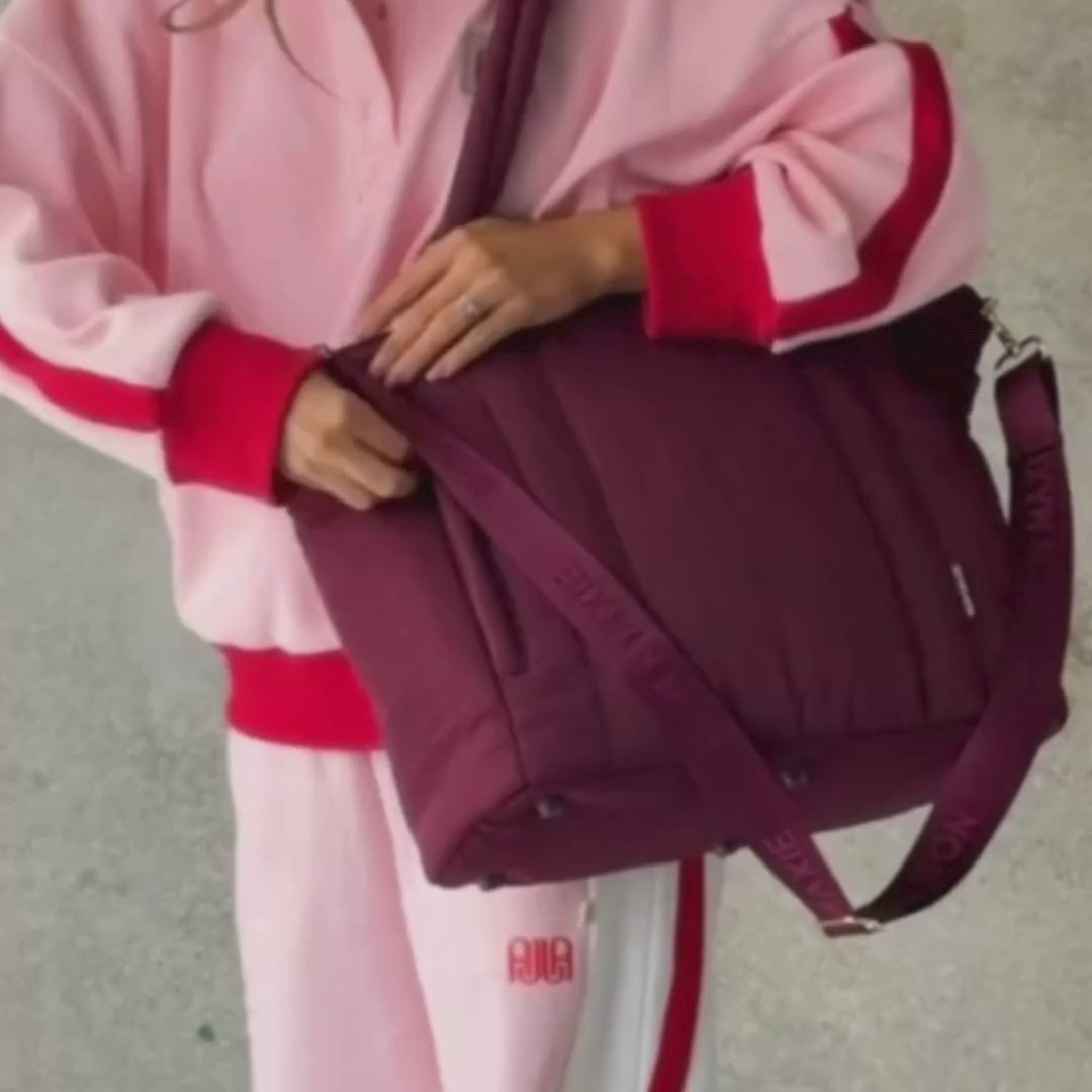 Load video: Woman demonstrating everyday tote in burgundy