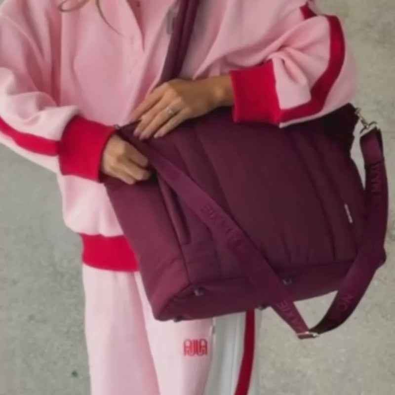 Woman demonstrating everyday tote in burgundy