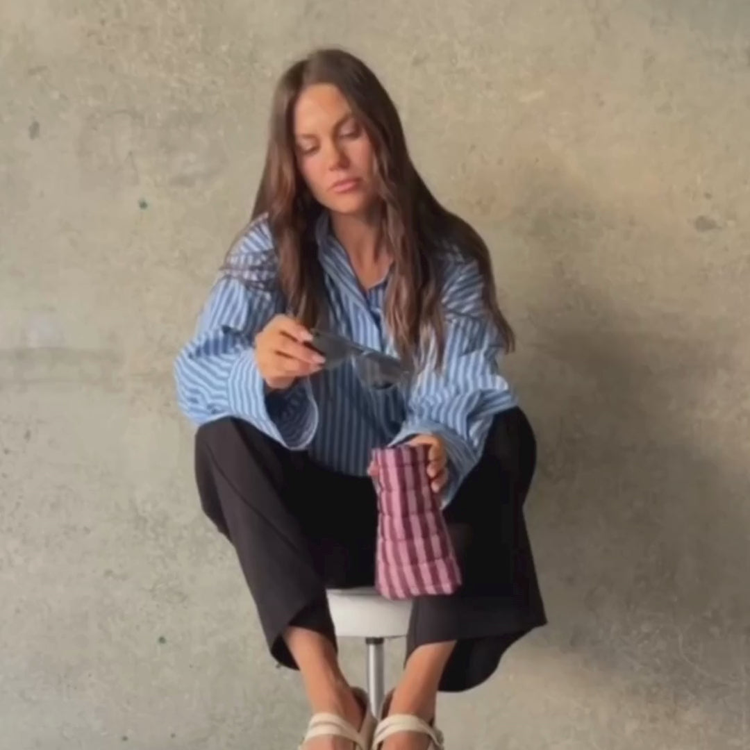 Load video: Woman demonstrating glasses case in burgundy milk tea stripe