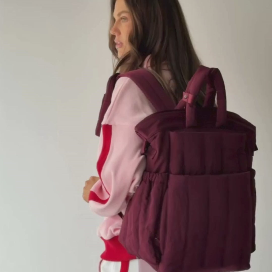 Load video: Woman demonstrating backpack in burgundy