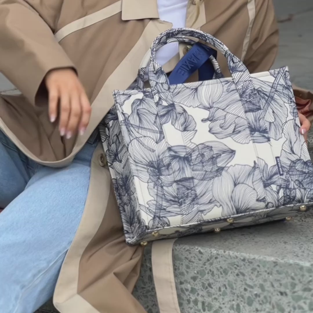 Load video: Small Structured Tote Bag in signature coated canvas -- Navy Floral