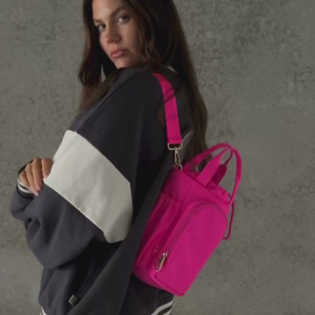 Load video: Woman demonstrating bottle bag in neon pink