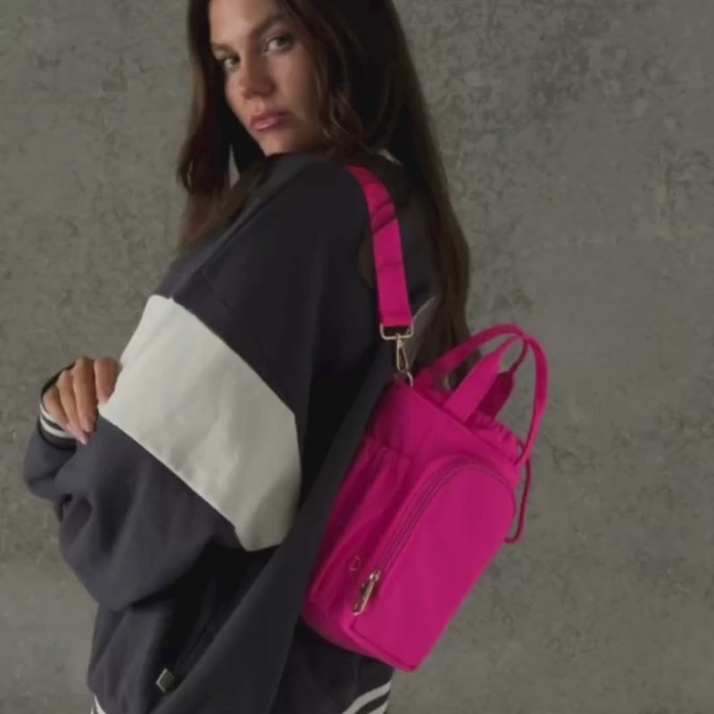 Woman demonstrating bottle bag in neon pink